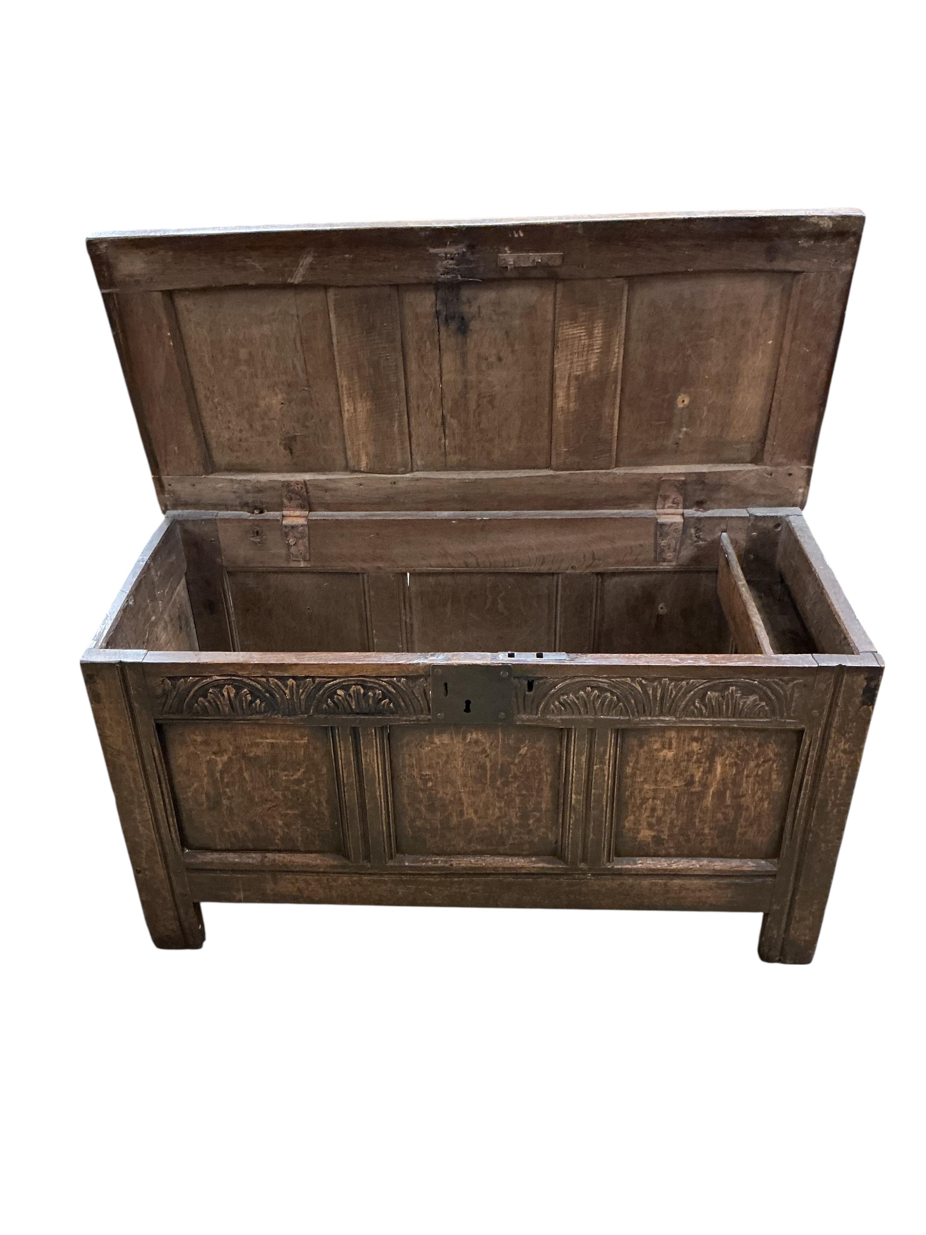 A small 17th century oak triple panelled coffer, width 106cm, depth 46cm, height 59cm